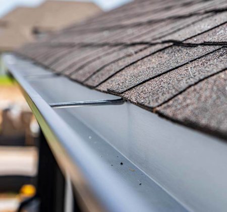 A close-up view of a gutter attached to a roof